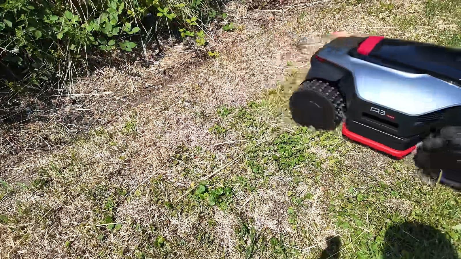 De Dreame A3 robotmaaier klimt omhoog op een droge, steile grashelling