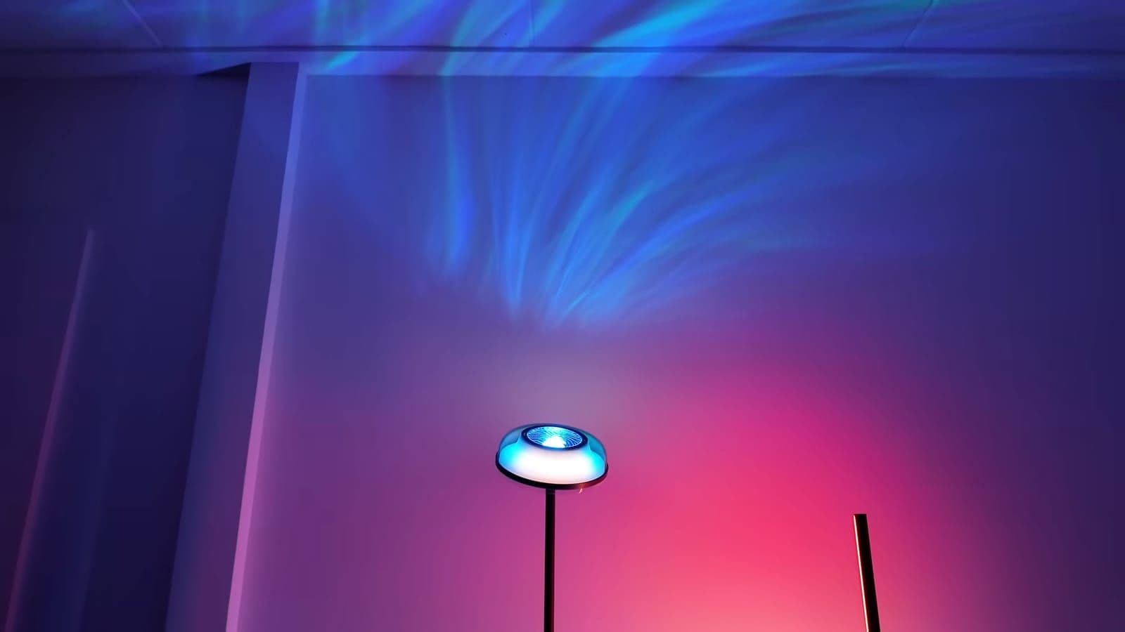 Blue water ripple patterns projected across the wall and ceiling above the Uplighter