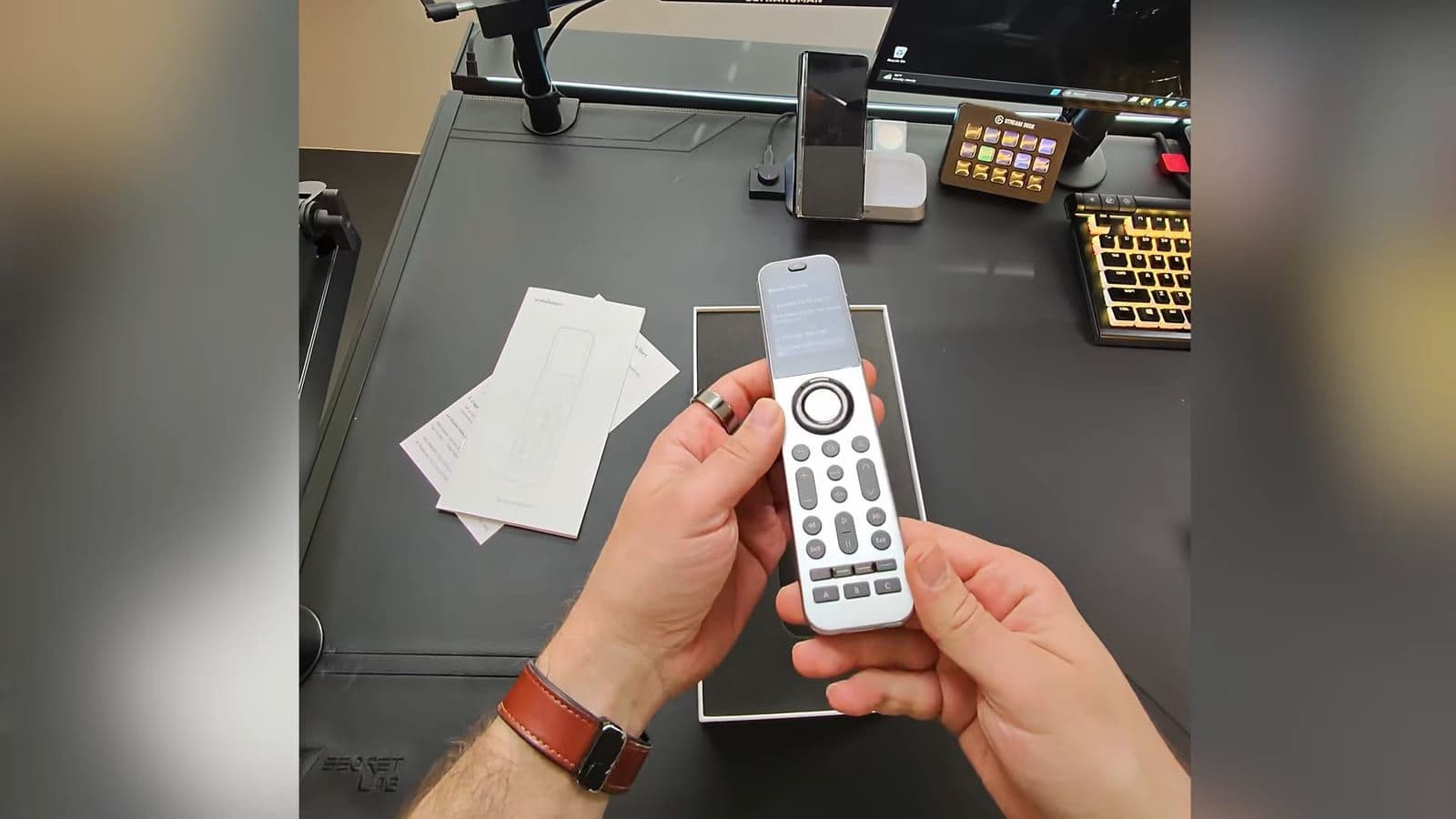 Close-up top view of the SofaBaton X2 remote unboxed in its presentation tray