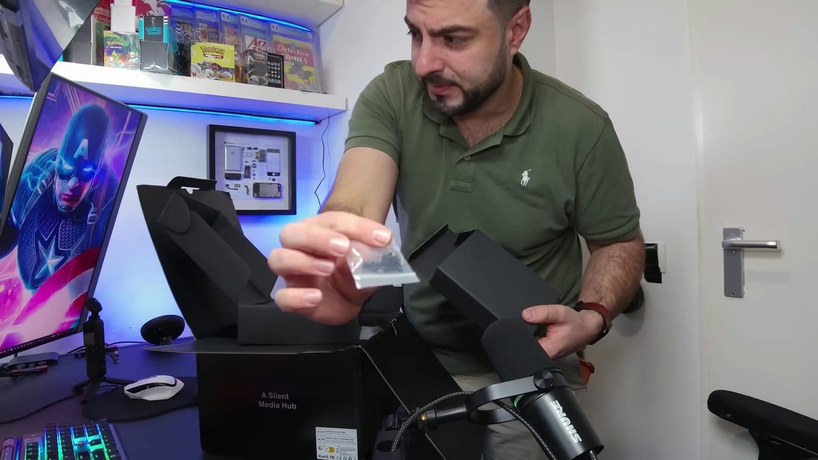Zino holding the small bag of screws alongside the unboxed accessories and packaging